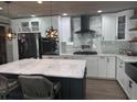 Modern kitchen features a large island, white cabinets, and stainless steel appliances at 2325 Audley St, Oviedo, FL 32765