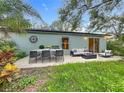 Inviting backyard patio featuring a dining area and cozy seating, perfect for outdoor living at 2353 Kingscrest Cir, Apopka, FL 32712