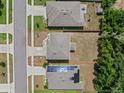 Aerial view of the property showing the layout of the house and surrounding yard at 253 Fiddlewood Ct, Davenport, FL 33837