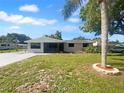 Charming single-story home featuring a screened porch, freshly painted exterior, and landscaped front yard at 2575 King Ave, Auburndale, FL 33823