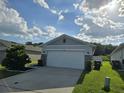 Attractive single-story home with a two-car garage, stone accents, and a well-manicured lawn at 3028 Lakes Crest Ave, St Cloud, FL 34772