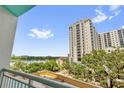 Balcony view overlooking a lake, greenery, and buildings on a sunny day at 322 E Central Blvd # 614, Orlando, FL 32801