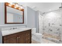 Bathroom featuring a marble vanity, modern sink fixtures, and a tiled walk-in shower at 322 E Central Blvd # 614, Orlando, FL 32801