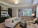 Open-concept living room with modern decor and seamless flow into the kitchen at 3458 Sagebrush St, Harmony, FL 34773