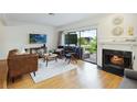 Bright living room with a fireplace, wood floors, and sliding glass doors to a private patio at 386 Lakeview St, Orlando, FL 32804