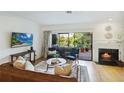 A sunlit living room featuring a cozy fireplace and seamless access to an outdoor space at 386 Lakeview St, Orlando, FL 32804