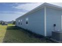 Exterior view of the home featuring blue siding and trim, plus many windows at 4167 Clifden Dr, Ormond Beach, FL 32174