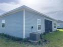 Exterior view of the home featuring blue siding and trim, plus a screened-in porch at 4167 Clifden Dr, Ormond Beach, FL 32174
