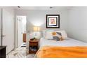 Cozy bedroom featuring patterned tile floors, a comfortable bed, and an ensuite bathroom at 4654 Alhama St, Orlando, FL 32811