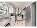 Efficient kitchen features updated appliances, white cabinets, and ample counter space for cooking at 4654 Alhama St, Orlando, FL 32811