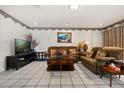 Cozy living room with comfortable seating, tile flooring, and decorative wall accents at 5324 Barefoot Path, Kissimmee, FL 34746