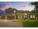 Charming home with three-car garage, well-kept lawn, and front yard with small palm trees at 748 Duff Dr, Winter Garden, FL 34787