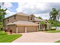 Beautiful two-story home with an attached three-car garage and neatly manicured landscaping at 748 Duff Dr, Winter Garden, FL 34787