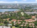 An aerial shot showcasing the neighborhood, nearby lake, and city skyline in the distance at 7856 Sugar Bend Dr # 7856, Orlando, FL 32819