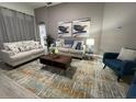 Comfortable living room with neutral walls, plush sofas, and an area rug over modern flooring at 8023 King Palm Cir, Kissimmee, FL 34747