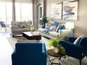 Bright living room featuring stylish furnishings, decor, and sliding glass doors to outdoor pool at 8023 King Palm Cir, Kissimmee, FL 34747
