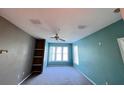 Bedroom with neutral carpet, ceiling fan, and large window at 8929 Legacy Ct # 208, Kissimmee, FL 34747