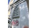 Close up of condo complex numbers and FACP sign on stucco building wall at 8929 Legacy Ct # 208, Kissimmee, FL 34747
