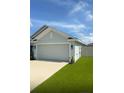 Charming single Gathering home featuring a two car garage, well maintained lawn, and welcoming front entrance at 1168 Citrus Landings Blvd, Davenport, FL 33837