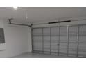 Spacious garage with automatic door, offering ample parking and storage space for vehicles and equipment at 1168 Citrus Landings Blvd, Davenport, FL 33837