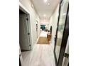 Bright hallway showcases wood floors and access to the living spaces at 1526 Hempel Ave, Gotha, FL 34734