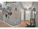 Inviting foyer with tile flooring and decorative wall accents create a warm and welcoming entrance at 1709 Kinsman Way, Lakeland, FL 33809