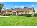 Well-kept home features a green lawn and manicured shrubs enhancing the property's curb appeal at 1709 Kinsman Way, Lakeland, FL 33809