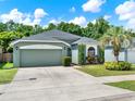 Inviting single-Gathering home featuring a two-car garage and beautiful landscaping in a serene setting at 1712 Riveredge Rd, Oviedo, FL 32766