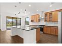 A spacious kitchen with a center island, wooden cabinets, and modern stainless steel appliances at 212 Lugano Way, Debary, FL 32713
