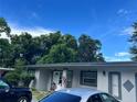 Charming single-story home with a well-kept lawn and multiple vehicles parked in front at 223 Hope Cir, Orlando, FL 32811