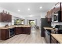Open kitchen featuring dark wood cabinets, granite countertops and stainless steel appliances at 2254 Canyon Breeze Ave, Kissimmee, FL 34746