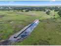 Long dock and picturesque waterfront access amidst a lush, natural setting at 2921 Lake Tohopekaliga Blvd, Kissimmee, FL 34746