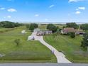 This property boasts a long driveway, lush lawn, multiple buildings, mature trees, and is fully fenced with lake views at 2921 Lake Tohopekaliga Blvd, Kissimmee, FL 34746