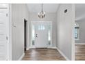Bright and airy foyer featuring hardwood floors, updated lighting, and a classic entry door at 3015 Riviera Bay Ct, Oviedo, FL 32765