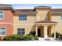 Charming townhome exterior featuring a well-manicured lawn and inviting front porch at 3061 Beach Palm Ave, Kissimmee, FL 34747