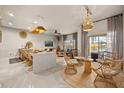 Open-concept living space with a modern kitchen, dining area, and comfortable seating, great for entertaining at 3061 Beach Palm Ave, Kissimmee, FL 34747