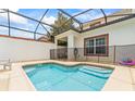 Private backyard pool with safety fence, perfect for relaxation and entertainment in a secure environment at 3193 Pequod Pl, Kissimmee, FL 34746