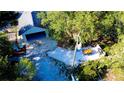 Expansive home with garage and outdoor dining space surrounded by lush greenery at 32645 Red Oak Dr, Eustis, FL 32736