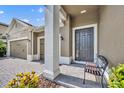 Inviting front porch with stylish door, stone accents, and well-maintained landscaping create an appealing entrance at 3454 Somerset Park Dr, Orlando, FL 32824