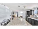 A modern kitchen featuring an island, granite countertops, and black cabinets at 4051 Crofford Ave, Haines City, FL 33844