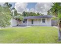 Charming single-story home with a well-manicured lawn and inviting front porch at 422 S Hawthorn Cir, Winter Springs, FL 32708