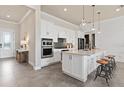 Modern kitchen featuring white cabinetry, stainless steel appliances, and a stylish island at 5101 Rising Ridge Dr, Mount Dora, FL 32757
