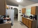 A well-lit kitchen with light wood cabinets, white appliances, and tile flooring at 5118 Laval Dr, Orlando, FL 32839