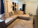 A cozy living room featuring a plush sectional sofa and neutral-toned decor at 5118 Laval Dr, Orlando, FL 32839