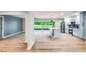 Open-concept kitchen boasts a center island, stainless steel appliances, and modern cabinets adjacent to a large living area at 5938 Marlberry Dr, Orlando, FL 32819