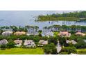 Aerial view of luxury homes with lush landscaping, serene lake views, and a golf course nearby at 6138 Greatwater Dr, Windermere, FL 34786