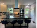 Modern kitchen features stainless appliances, a large island, and bar stool seating at 740 Naples Dr, Orlando, FL 32804