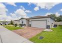 A charming single-Gathering home with a two-car garage and a well-maintained front lawn at 840 Teton St, Haines City, FL 33844