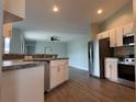 Modern kitchen featuring stainless steel appliances, granite countertops, and sleek cabinetry at 8414 Sw 136Th Pl, Ocala, FL 34473