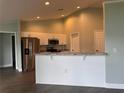 Bright kitchen with white cabinets, stainless steel appliances, and granite countertops at 8414 Sw 136Th Pl, Ocala, FL 34473